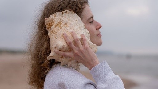 Woman listening to seashell.jpg